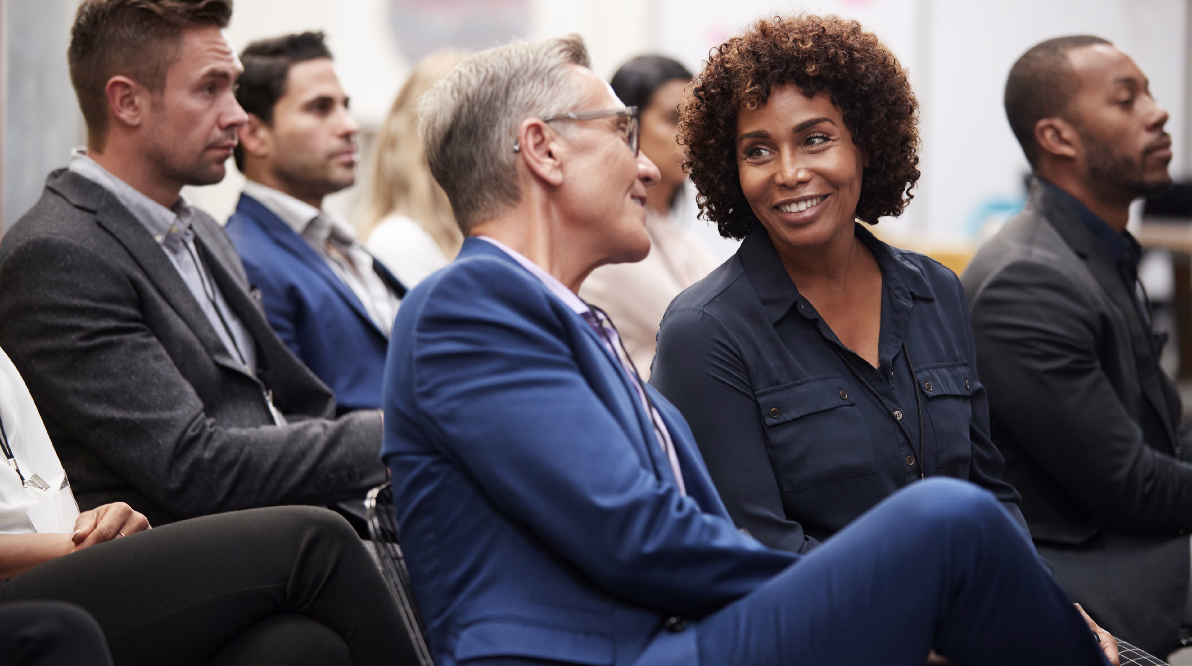 An audience smiling during an event session