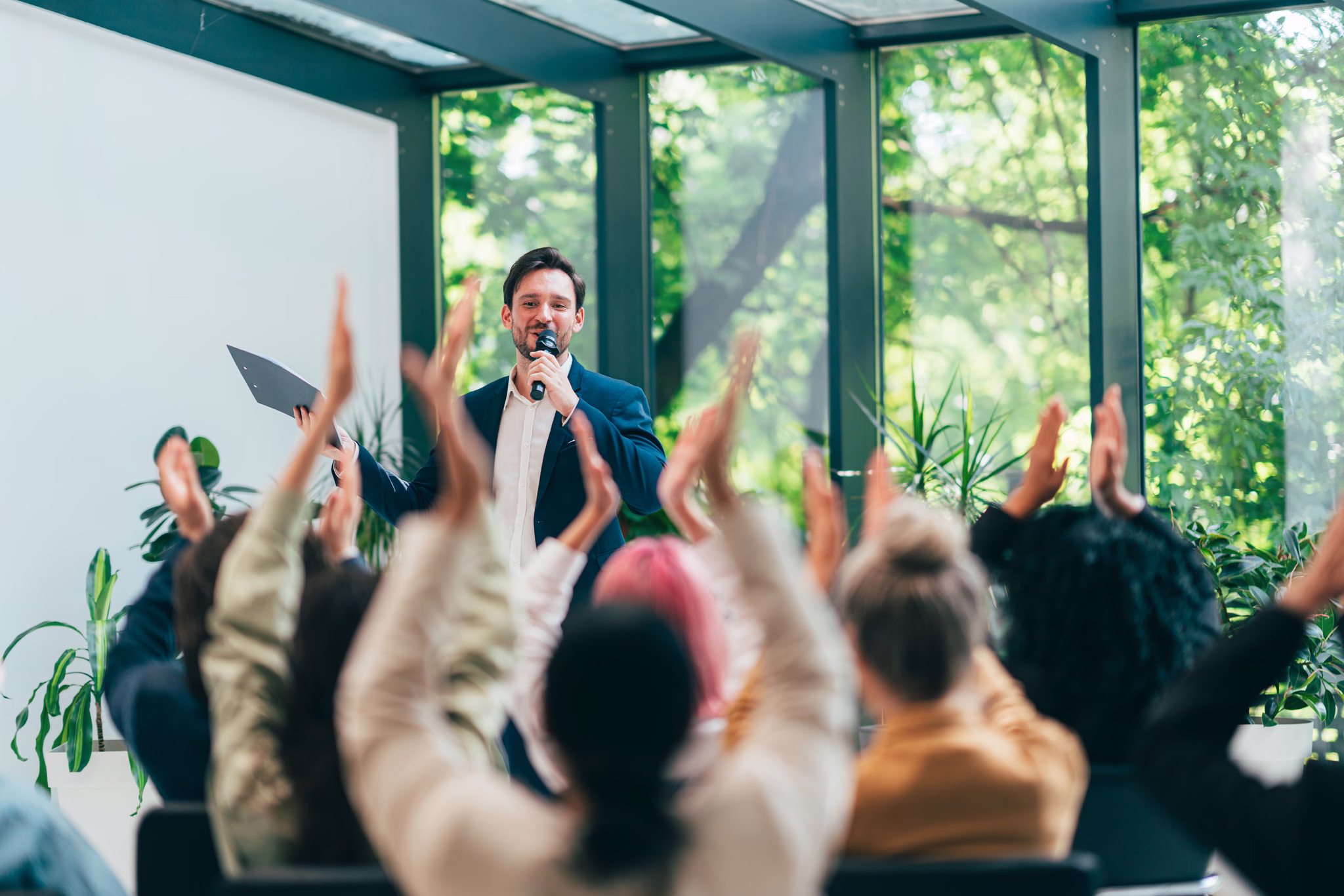 An audience applauding a speaker